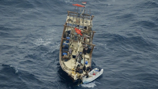 Pirates abandoning a pirated dhow at the height of piracy in 2011 (archives B2 - Credit: CBC)