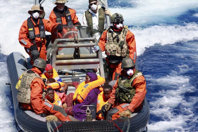 Transfer of refugees from HMS Enterprise to Schleswig-Holstein. On the boat (on the right in purple, A. Rahma who will give birth to Sophia) - Credit: Bundeswehr